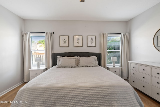 bedroom with baseboards and wood finished floors