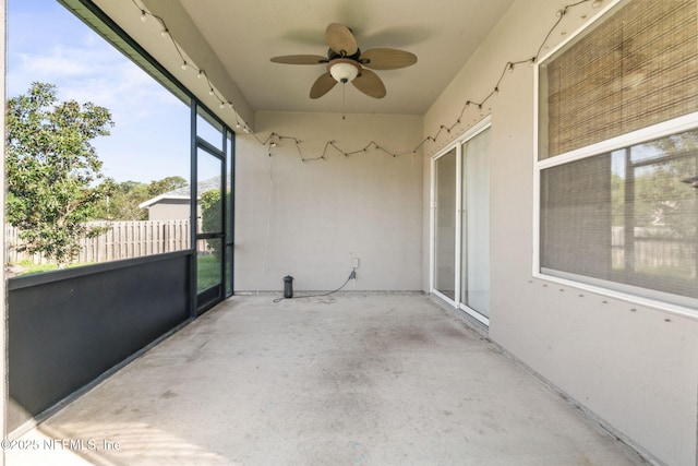 exterior space with ceiling fan and fence