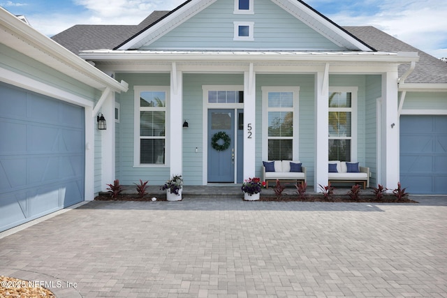 52 Sunshine Bass Ct, Ponte Vedra, FL 32081 - entrance to property with decorative driveway, covered porch, a shingled roof, and a garage