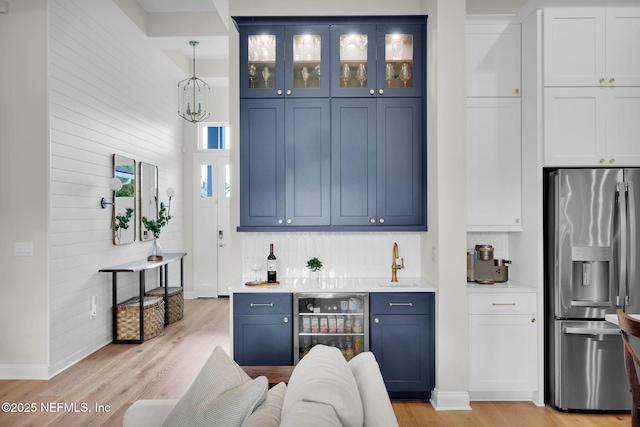 52 Sunshine Bass Ct, Ponte Vedra, FL 32081 - bar with a sink, beverage cooler, light wood-type flooring, indoor wet bar, and stainless steel fridge