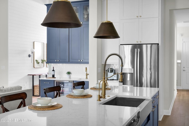 52 Sunshine Bass Ct, Ponte Vedra, FL 32081 - kitchen featuring beverage cooler, wood finished floors, blue cabinetry, stainless steel fridge with ice dispenser, and a sink