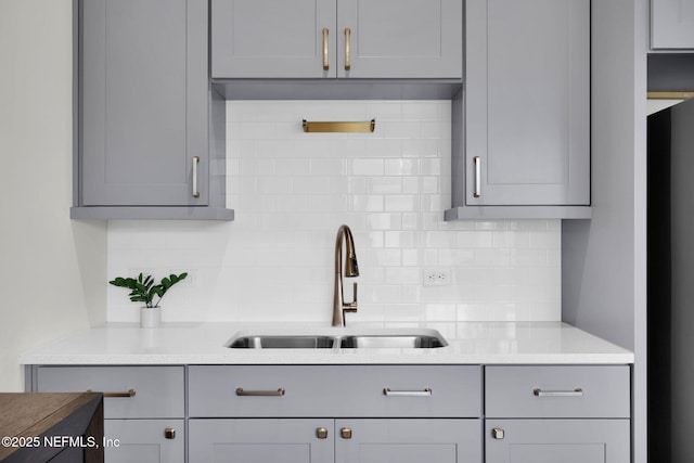 52 Sunshine Bass Ct, Ponte Vedra, FL 32081 - kitchen featuring tasteful backsplash, gray cabinetry, and a sink