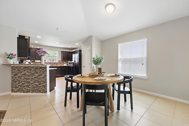 dining space featuring recessed lighting, light tile patterned floors, and baseboards