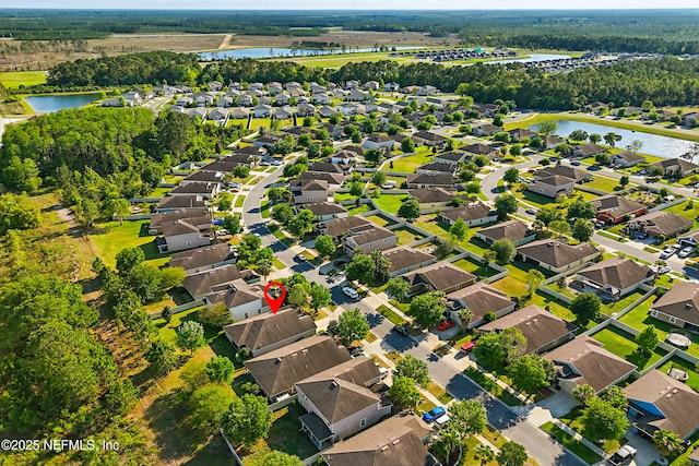 bird's eye view with a water view and a residential view