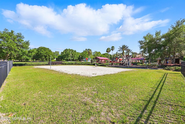 view of home's community with a yard, fence, and volleyball court