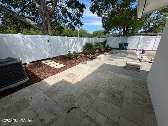 1124 Oceanwood Dr S, Neptune Beach, FL 32266 - fenced backyard featuring central air condition unit, a patio, and a gate