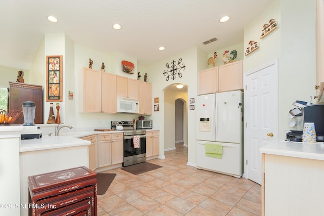 13772 Chipperfield Ln, Jacksonville, FL 32226 - kitchen with visible vents, white appliances, arched walkways, and light brown cabinetry