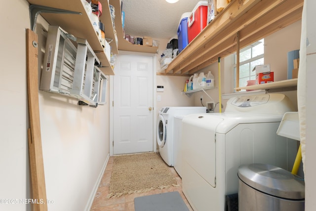13772 Chipperfield Ln, Jacksonville, FL 32226 - washroom featuring washer and dryer, baseboards, a textured ceiling, and laundry area