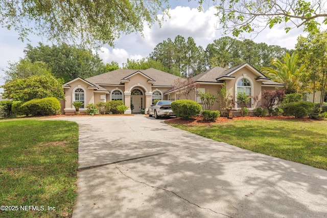 13772 Chipperfield Ln, Jacksonville, FL 32226 - view of front of property featuring concrete driveway, a front yard, and stucco siding