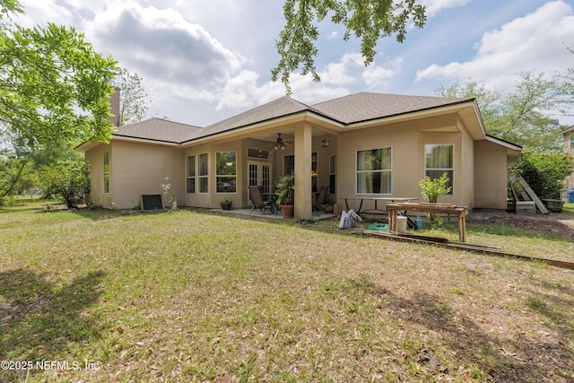 13772 Chipperfield Ln, Jacksonville, FL 32226 - back of house with a chimney, stucco siding, ceiling fan, a patio area, and a lawn