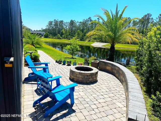 view of patio / terrace with a water view and an outdoor fire pit