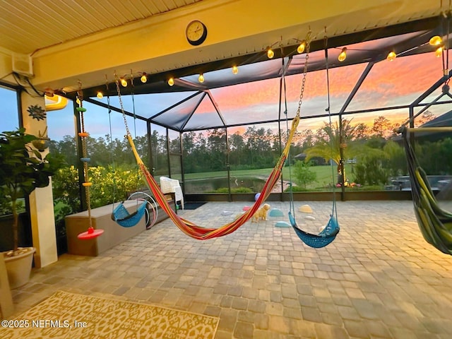 playground at dusk with a patio and a lanai
