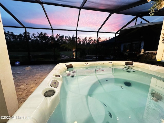 view of swimming pool with a lanai and a hot tub