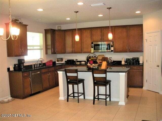 46 Molasses Ct, Jacksonville, FL 32259 - kitchen featuring recessed lighting, a kitchen island, appliances with stainless steel finishes, a sink, and dark countertops