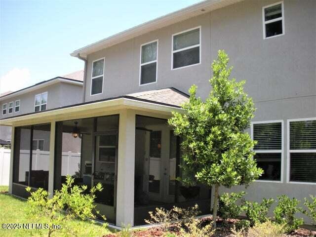 46 Molasses Ct, Jacksonville, FL 32259 - rear view of property featuring stucco siding and a sunroom