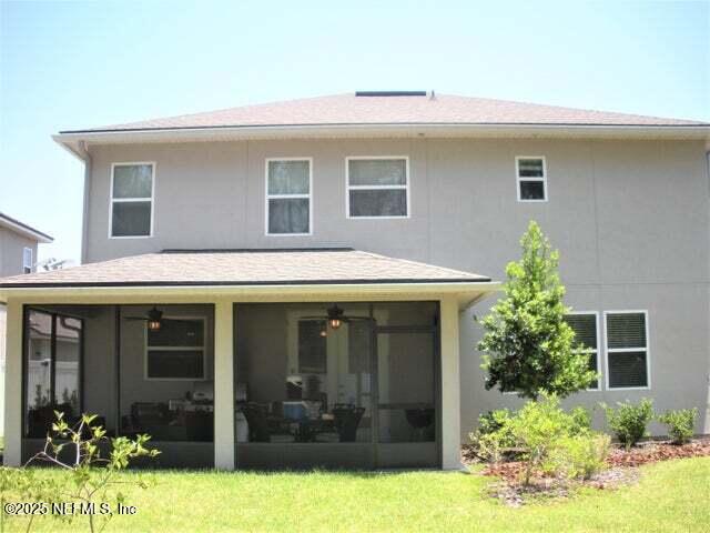 46 Molasses Ct, Jacksonville, FL 32259 - back of house featuring a sunroom and stucco siding