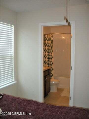 46 Molasses Ct, Jacksonville, FL 32259 - unfurnished bedroom with light carpet, ensuite bathroom, and multiple windows