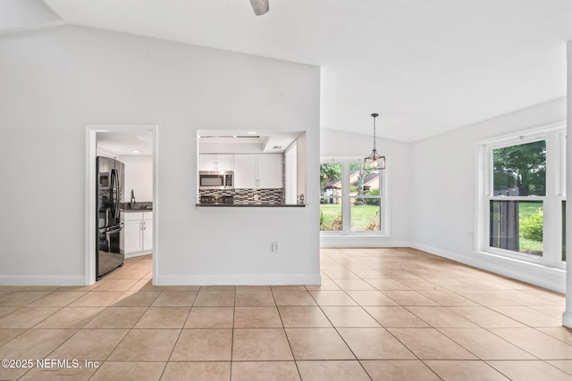 765 Sea Oats Bay, Ponte Vedra Beach, FL 32082 - unfurnished living room with light tile patterned floors, vaulted ceiling, and a healthy amount of sunlight