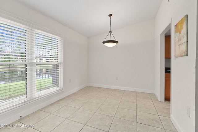 810 Sandpiper Ln, Ponte Vedra Beach, FL 32082 - empty room featuring baseboards, light tile patterned floors, and a healthy amount of sunlight