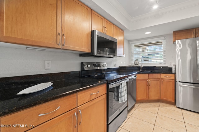 810 Sandpiper Ln, Ponte Vedra Beach, FL 32082 - kitchen with ornamental molding, dark stone counters, a sink, appliances with stainless steel finishes, and light tile patterned floors