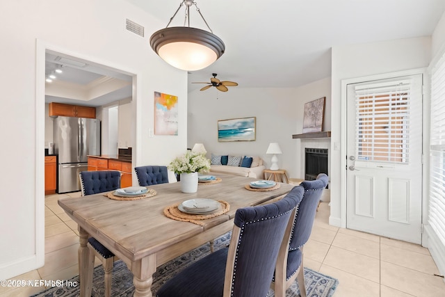 810 Sandpiper Ln, Ponte Vedra Beach, FL 32082 - dining room with visible vents, ceiling fan, light tile patterned flooring, and a fireplace