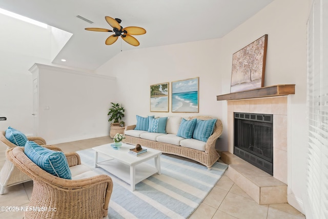 810 Sandpiper Ln, Ponte Vedra Beach, FL 32082 - living room featuring ceiling fan, visible vents, a tiled fireplace, light tile patterned floors, and lofted ceiling