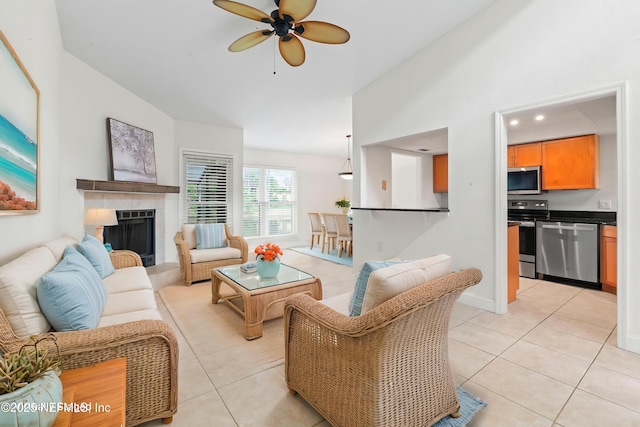 810 Sandpiper Ln, Ponte Vedra Beach, FL 32082 - living room with vaulted ceiling, light tile patterned floors, a fireplace, and a ceiling fan
