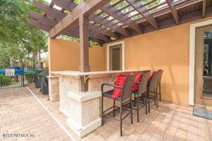 810 Sandpiper Ln, Ponte Vedra Beach, FL 32082 - view of patio with outdoor dry bar and a pergola