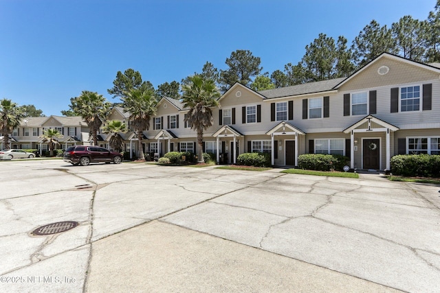 view of front of home with uncovered parking and a residential view