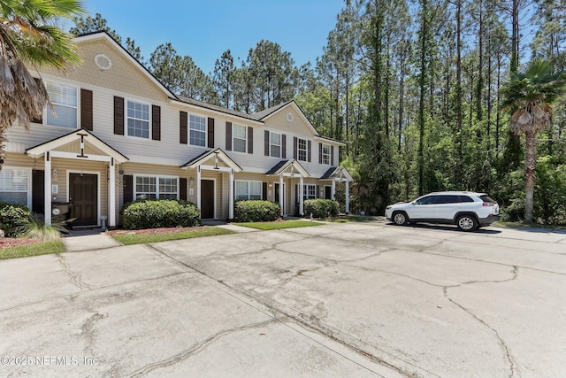 townhome / multi-family property featuring uncovered parking