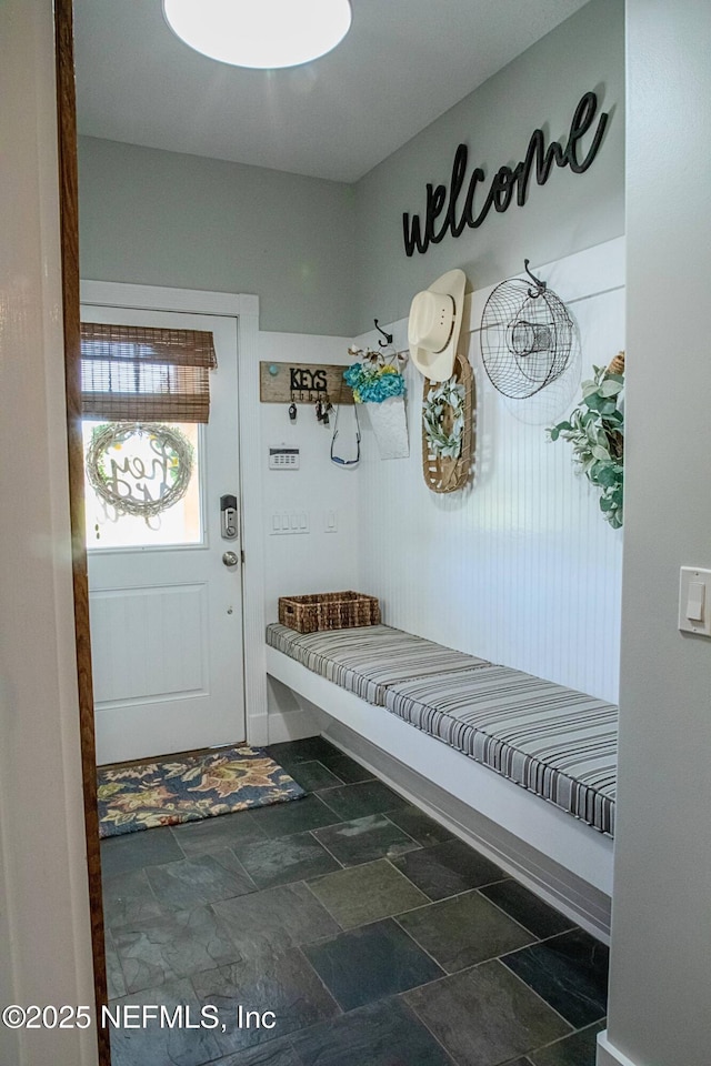 mudroom featuring stone finish floor