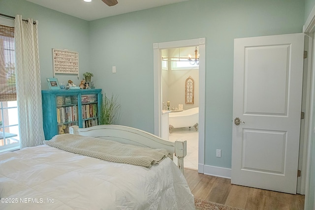 bedroom with baseboards and wood finished floors