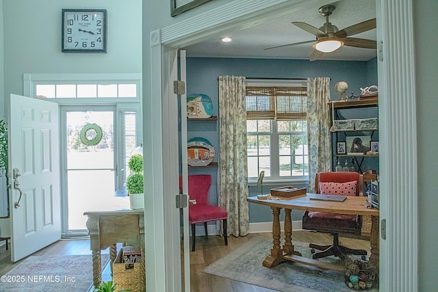 interior space featuring a ceiling fan and wood finished floors