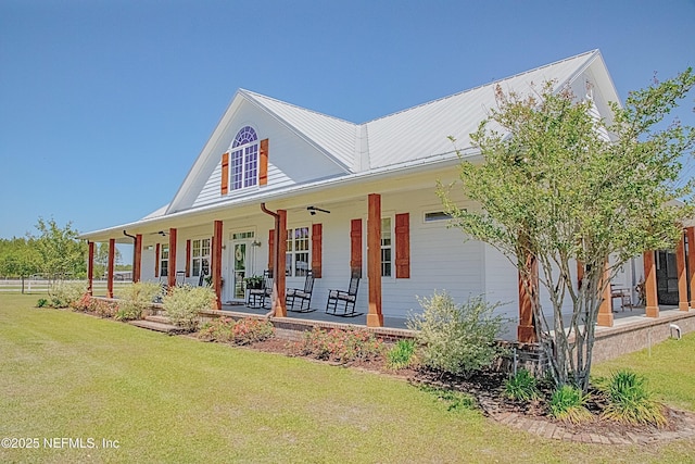 view of front of house with a porch, a front lawn, and fence