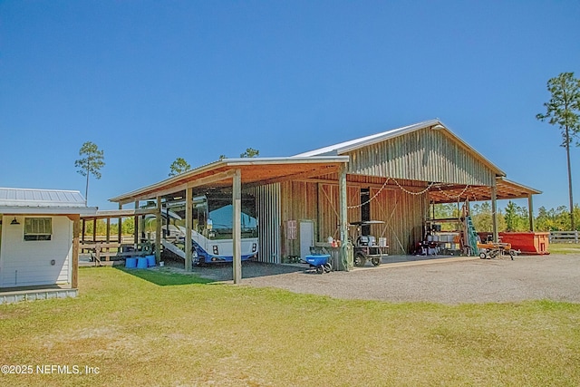 exterior space featuring gravel driveway, an outdoor structure, and an exterior structure
