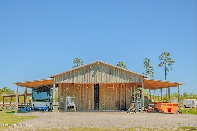 exterior space with a carport, an outdoor structure, and an exterior structure
