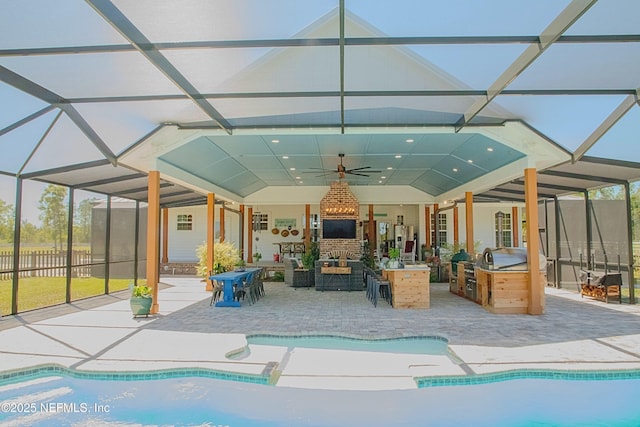 outdoor pool with ceiling fan, glass enclosure, area for grilling, and a patio
