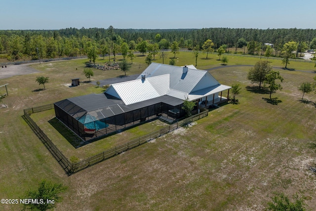 birds eye view of property with a view of trees