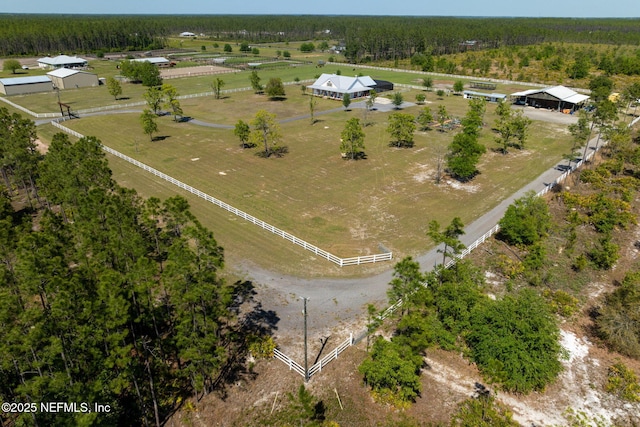 birds eye view of property featuring a rural view and a forest view