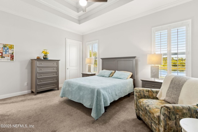bedroom featuring crown molding, baseboards, carpet floors, and a raised ceiling