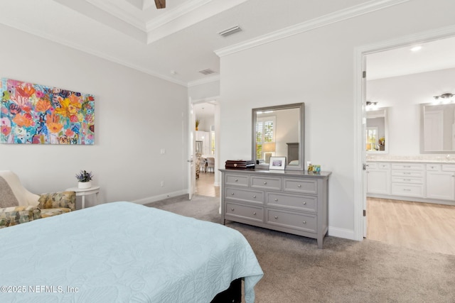 bedroom with crown molding, baseboards, light colored carpet, and visible vents