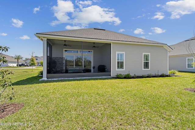 rear view of property with a lawn, ceiling fan, and a patio area