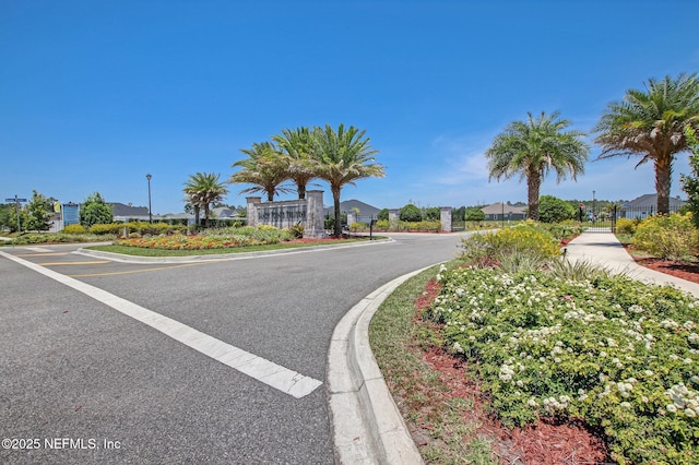 view of road featuring street lighting, a residential view, and curbs