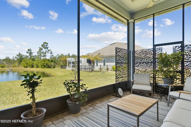 sunroom with a water view and a wealth of natural light