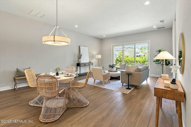 dining area featuring wood finished floors, baseboards, visible vents, and recessed lighting