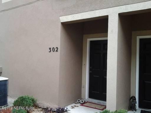 12301 Kernan Forest Blvd Unit 302, Jacksonville, FL 32225 - view of exterior entry with stucco siding