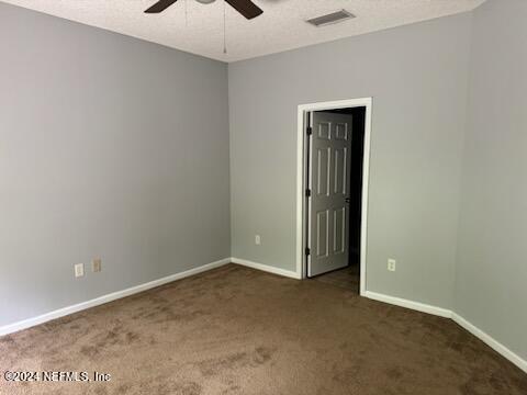 12301 Kernan Forest Blvd Unit 302, Jacksonville, FL 32225 - unfurnished room with baseboards, carpet flooring, ceiling fan, and visible vents