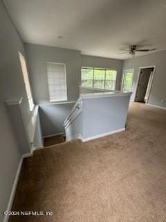 12301 Kernan Forest Blvd Unit 302, Jacksonville, FL 32225 - unfurnished living room with baseboards, ceiling fan, and carpet