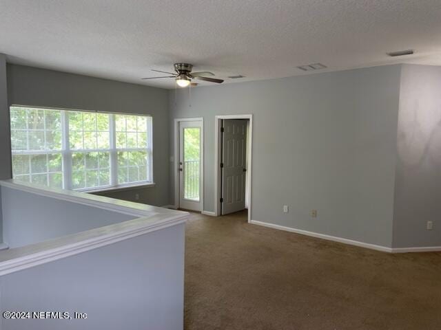 12301 Kernan Forest Blvd Unit 302, Jacksonville, FL 32225 - unfurnished room featuring carpet flooring, a textured ceiling, a ceiling fan, baseboards, and visible vents