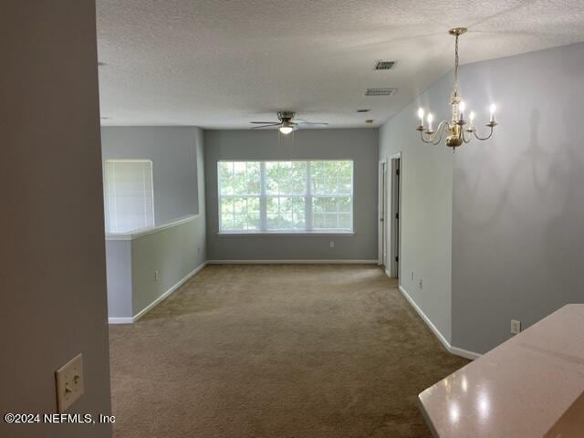 12301 Kernan Forest Blvd Unit 302, Jacksonville, FL 32225 - interior space featuring ceiling fan with notable chandelier, baseboards, carpet flooring, and a textured ceiling